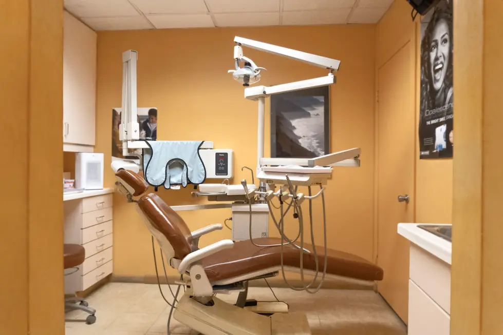 A treatment room at Connecticut Dental Group with a dental chair, overhead light and panoramic X-ray unit